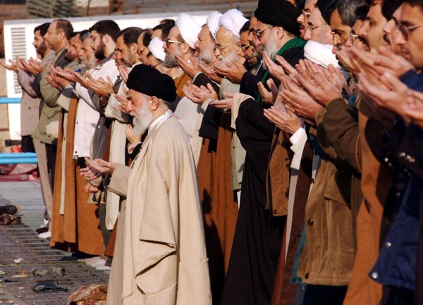אנשי הדת מעדיפים לנהל ולעשות כסף. המנהיג העליון של איראן, עלי ח'אמנאי מוביל תפילה במסגד ח'ומייני בטהראן (צילום: Keivan/Getty Images)