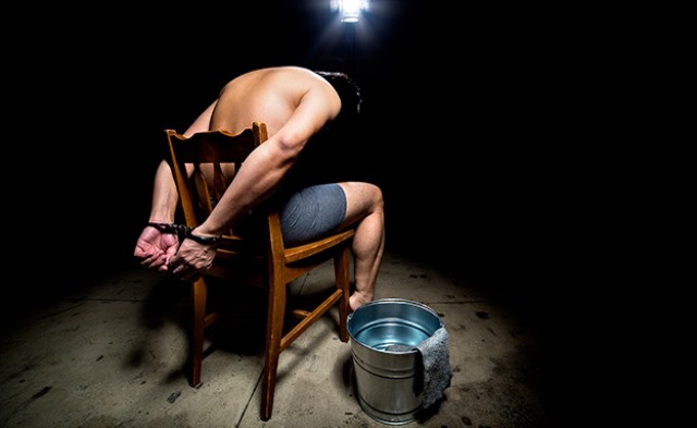 Prisoner being punished with cruel interrogation technique of waterboarding